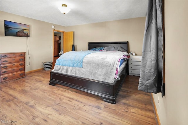 bedroom with hardwood / wood-style flooring