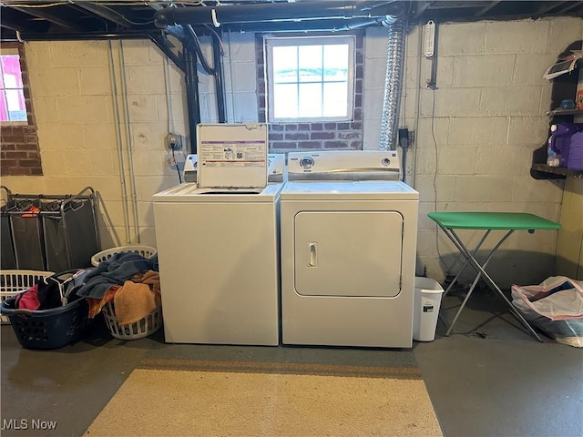 washroom with a wealth of natural light and washer and clothes dryer