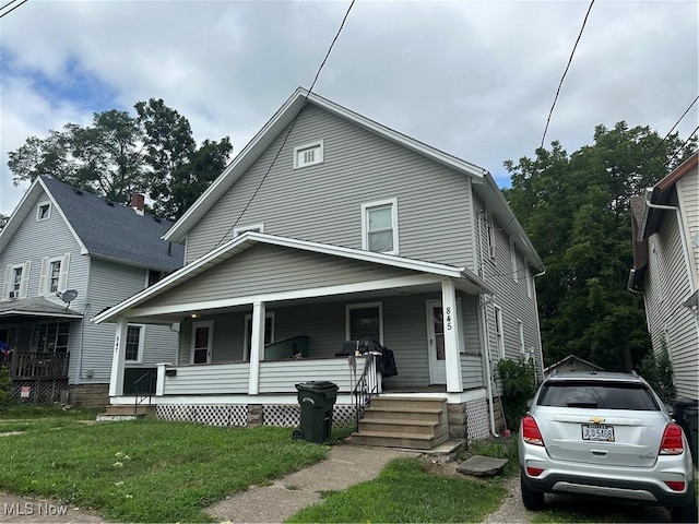 view of front of home featuring a front lawn and a porch