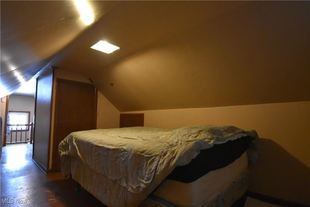 bedroom with lofted ceiling