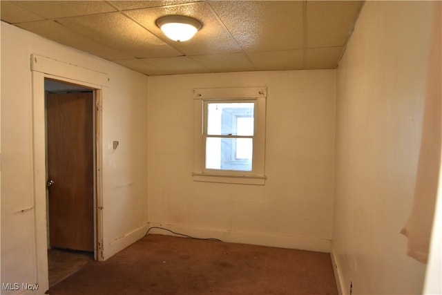 empty room featuring a drop ceiling