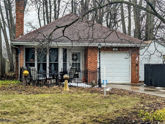 view of front of home featuring a garage, a front yard, a chimney, and brick siding