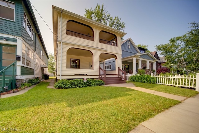 view of front of home featuring covered porch and a front yard