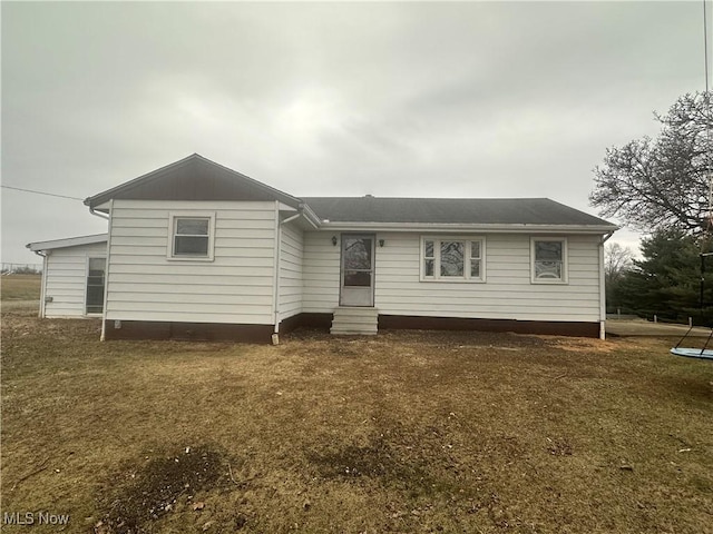 rear view of property with a yard