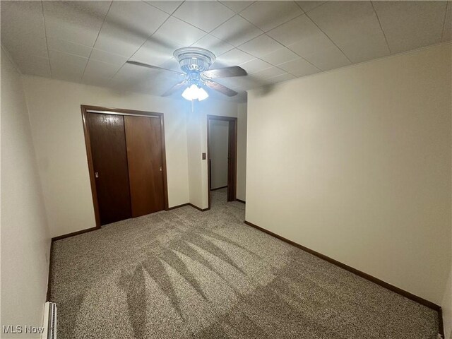1425 Flint Ridge Rd, Hopewell, OH 43746 - unfurnished bedroom featuring a closet, carpet flooring, ceiling fan, and baseboard heating
