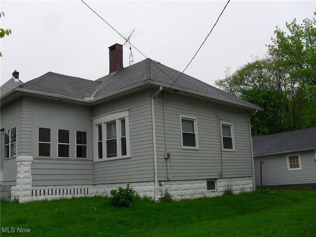 view of property exterior featuring a lawn