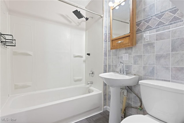 full bathroom with tile walls, tub / shower combination, tasteful backsplash, and toilet