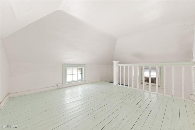 bonus room with wood-type flooring and lofted ceiling