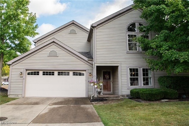 view of front property featuring a front lawn and a garage