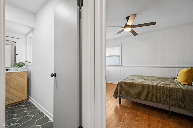 bedroom with dark wood-type flooring and ceiling fan