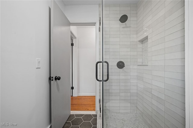 bathroom with tile patterned floors and walk in shower