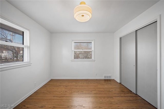 unfurnished bedroom featuring a closet and wood-type flooring