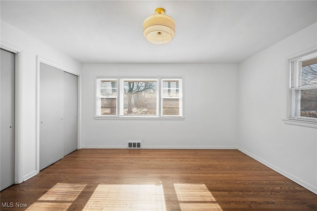 unfurnished bedroom featuring hardwood / wood-style flooring