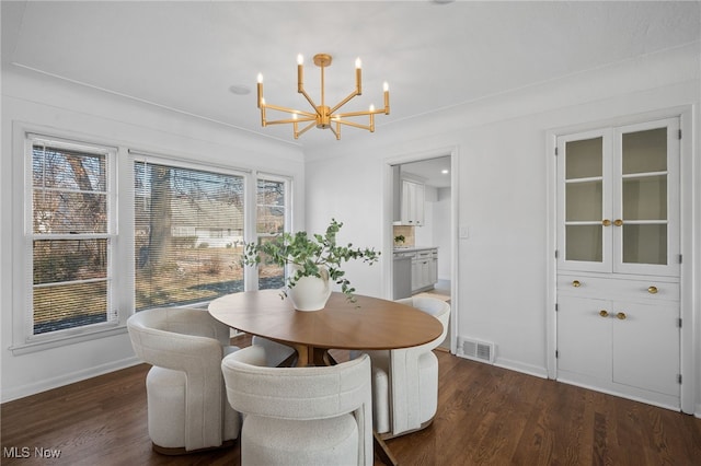 dining area featuring an inviting chandelier and dark hardwood / wood-style floors