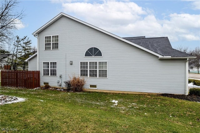 rear view of house with a lawn