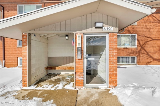 view of snow covered property entrance