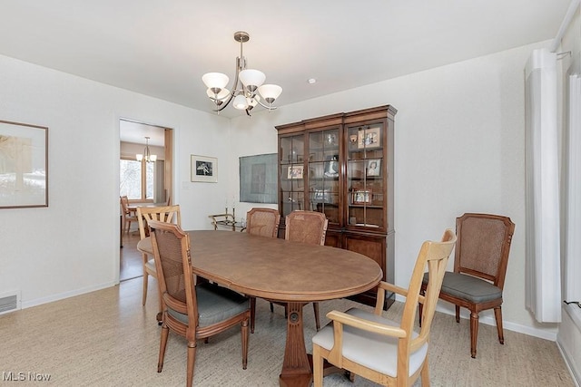 dining room featuring a notable chandelier