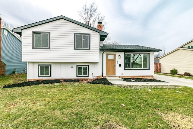 split level home featuring a front lawn