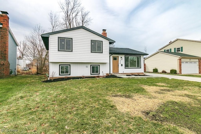 split level home with a garage and a front yard