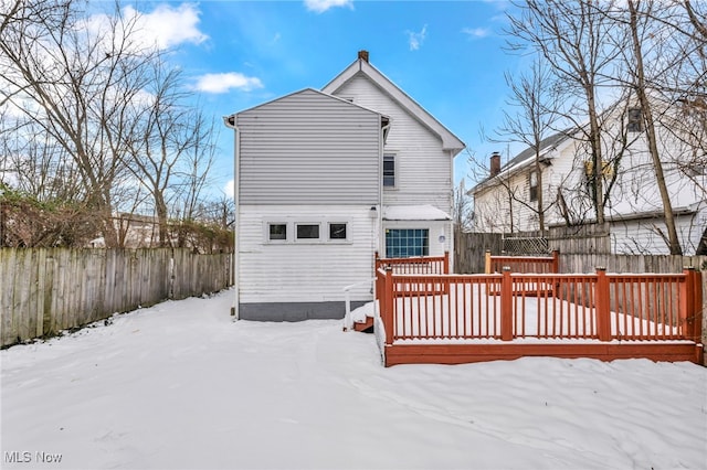 snow covered property with a deck