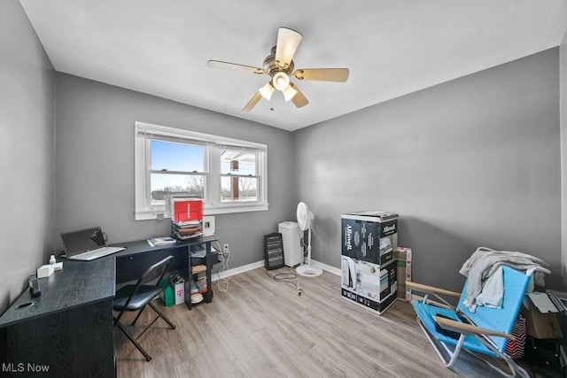 home office with ceiling fan and light wood-type flooring