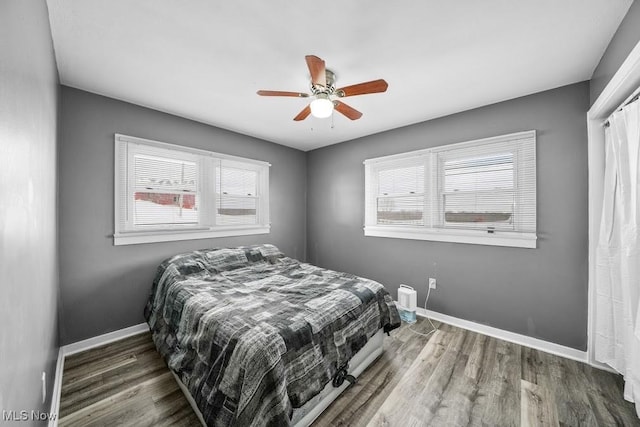 bedroom featuring dark hardwood / wood-style flooring and ceiling fan