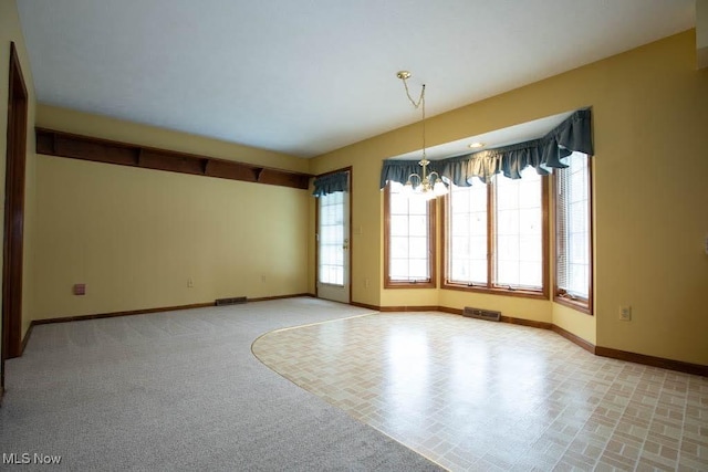 empty room featuring a chandelier