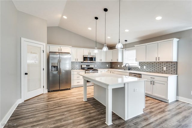 kitchen with white cabinets, a center island, and stainless steel appliances