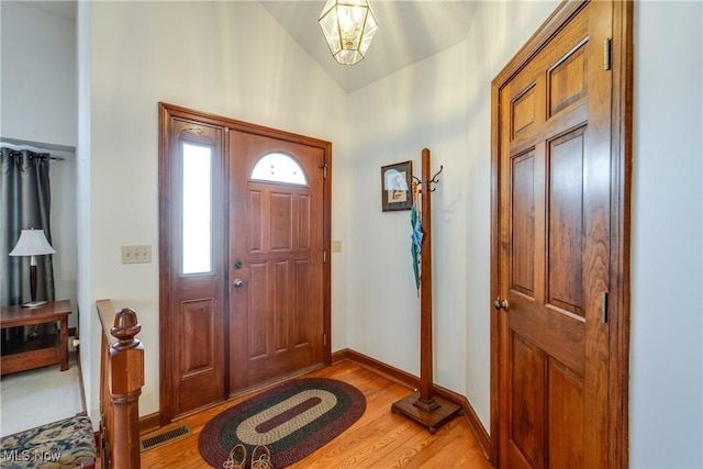 entrance foyer with light wood-type flooring and lofted ceiling