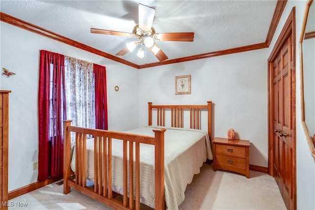 bedroom with ceiling fan, ornamental molding, a textured ceiling, and light colored carpet