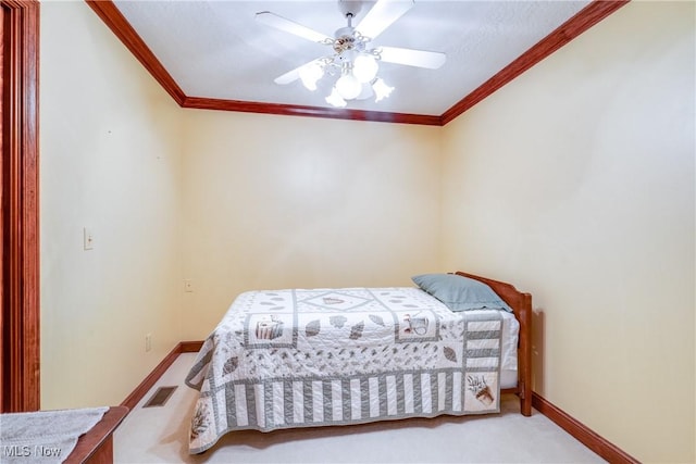 bedroom featuring ceiling fan, carpet flooring, and ornamental molding