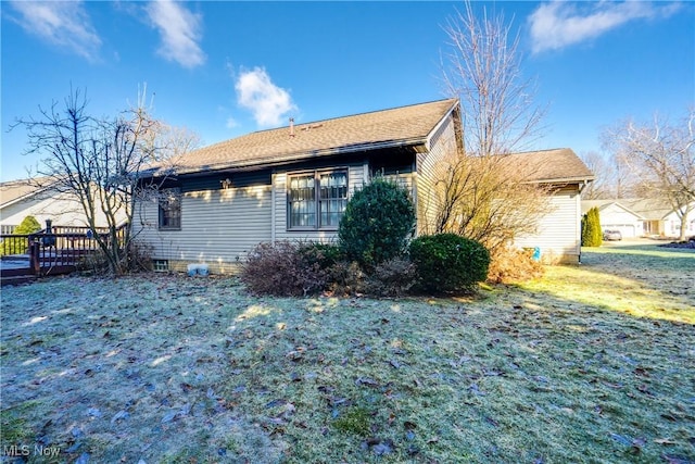 view of side of home featuring a yard