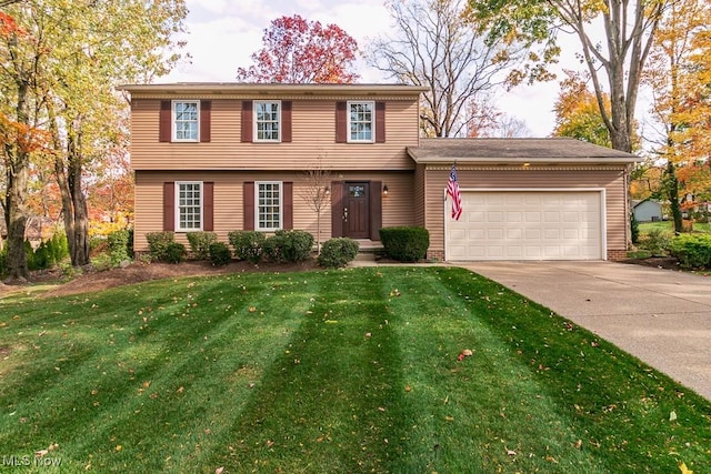 view of front of property featuring a garage and a front lawn