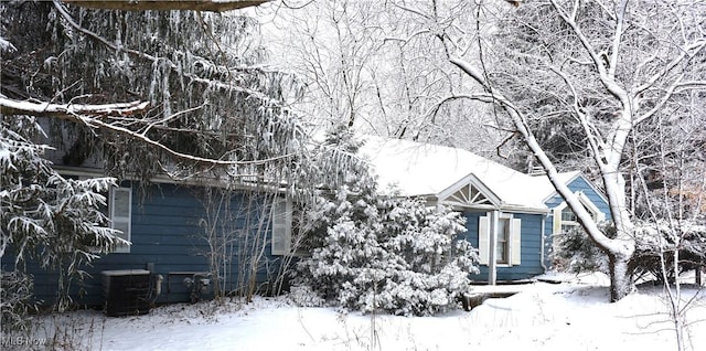 view of snowy exterior with cooling unit