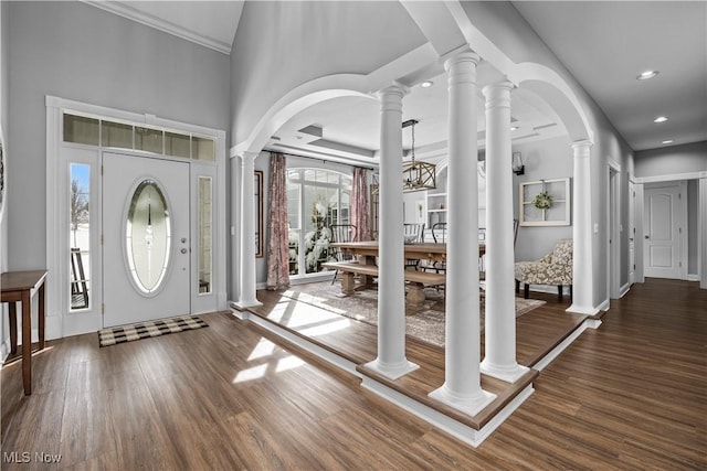 entrance foyer featuring a high ceiling, decorative columns, and dark hardwood / wood-style floors