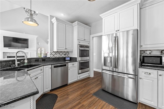 kitchen featuring white cabinets, stainless steel appliances, and sink