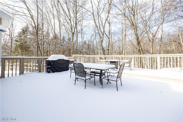 snow covered deck featuring a grill