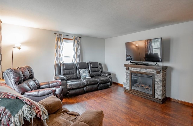 living room featuring a fireplace, a textured ceiling, and dark hardwood / wood-style flooring