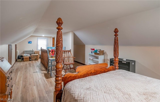 bedroom with light hardwood / wood-style flooring and lofted ceiling