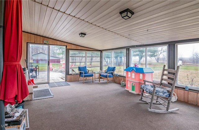 sunroom featuring vaulted ceiling and plenty of natural light