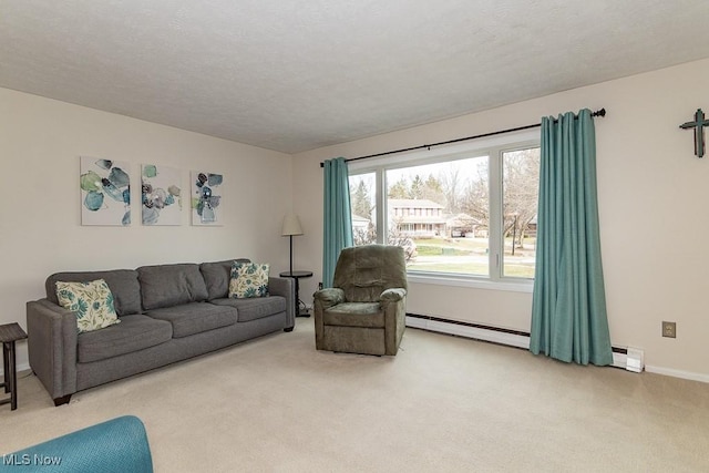 carpeted living room with baseboard heating and a textured ceiling