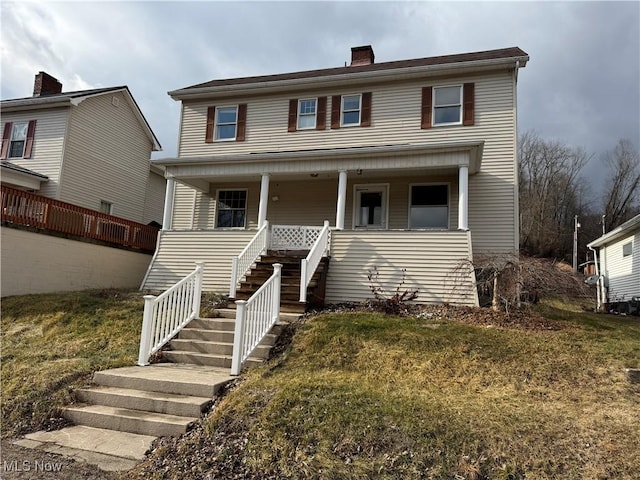 view of front of house with a front lawn and a porch