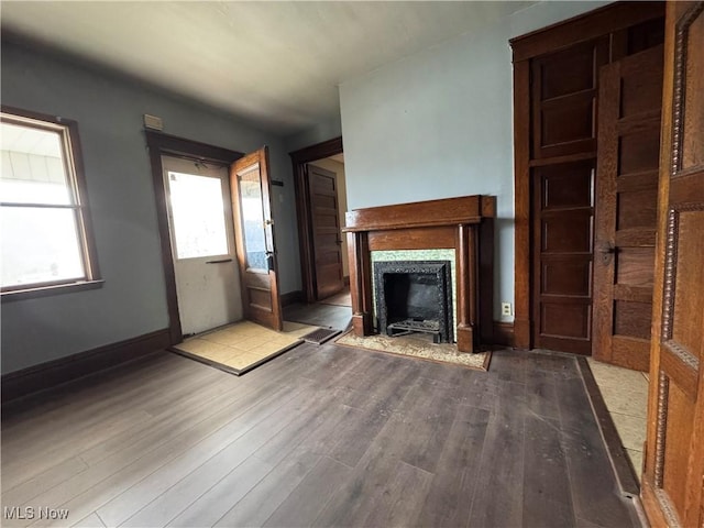 unfurnished living room with light hardwood / wood-style flooring and a premium fireplace