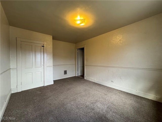 unfurnished bedroom featuring a closet and carpet floors