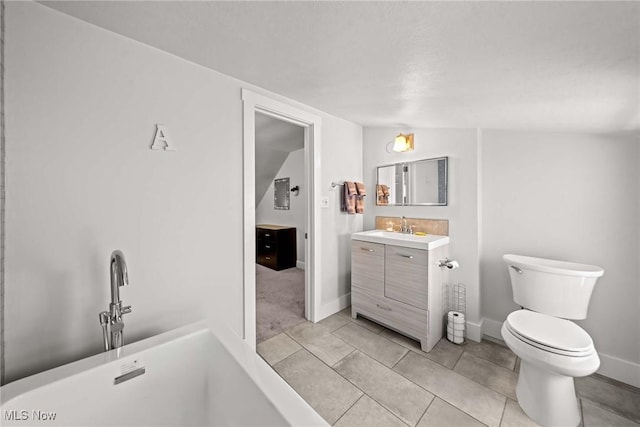 bathroom with toilet, a washtub, vaulted ceiling, tile patterned floors, and vanity