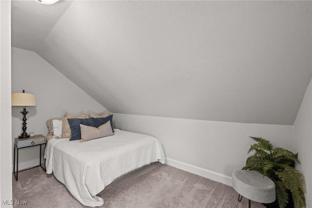 bedroom featuring carpet and lofted ceiling