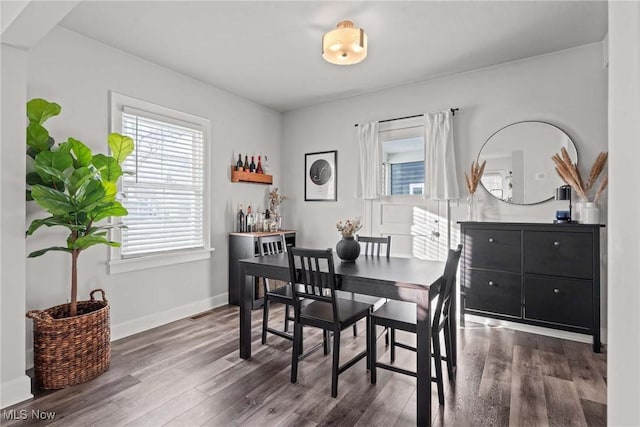 dining space with dark wood-type flooring