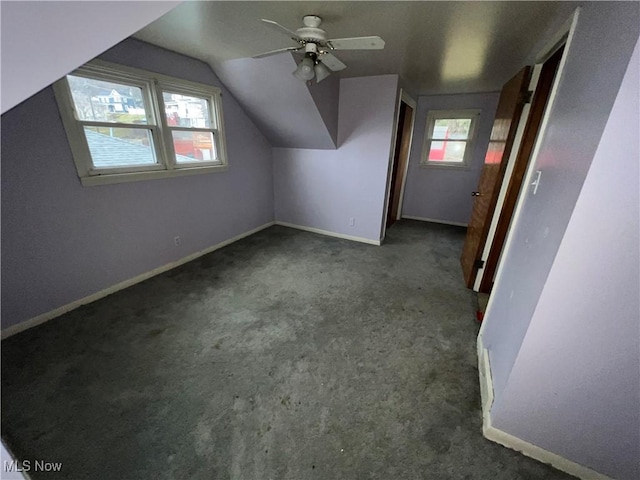 bonus room featuring dark carpet, ceiling fan, and lofted ceiling