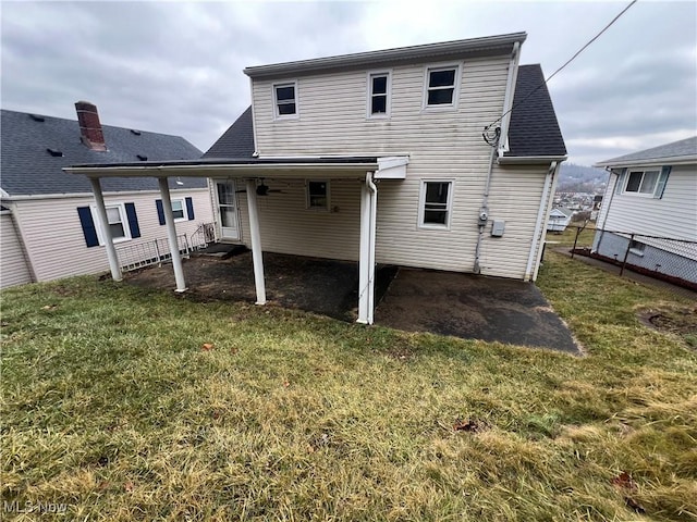 rear view of house featuring a lawn