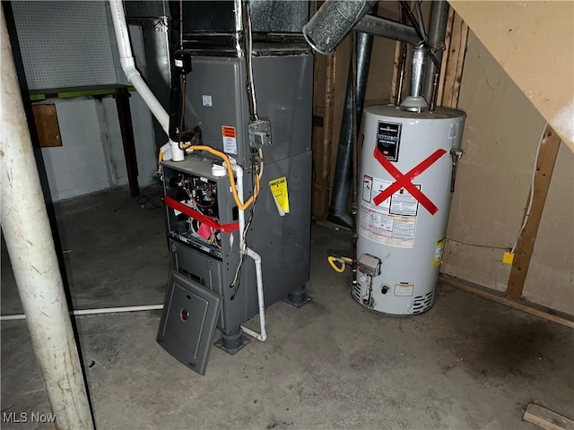 utility room featuring heating unit and water heater